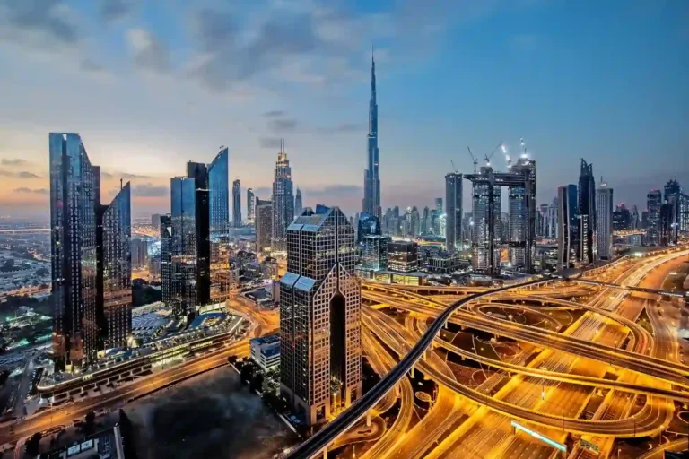 A breathtaking aerial view of the Dubai skyline at twilight, showcasing the city's financial district and infrastructure. Kloudac, a premier accounting firm in Dubai, offers comprehensive accounting services and expert guidance for seamless business setup and registration.