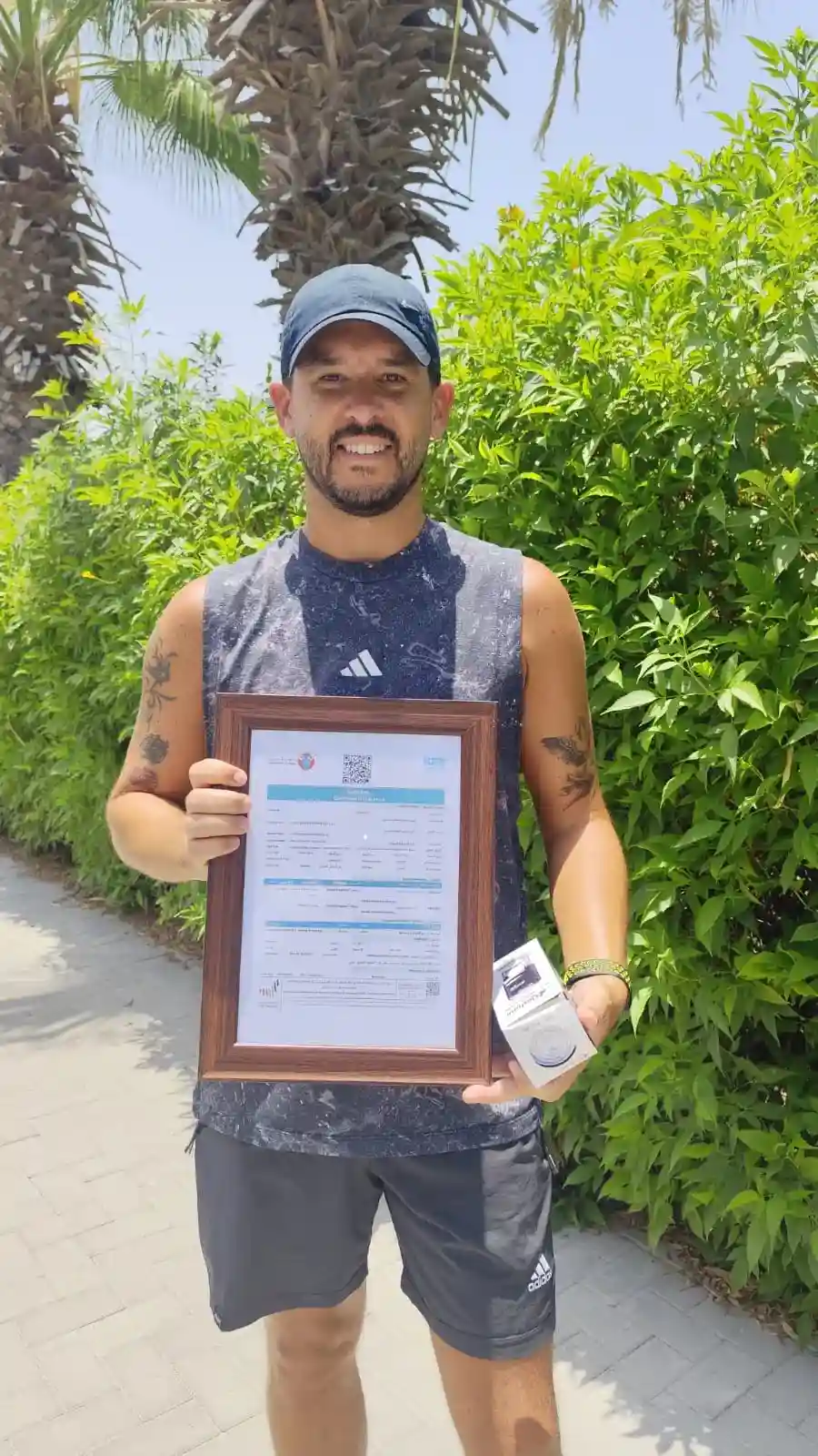 A happy entrepreneur holding his framed commercial license outdoors, celebrating a successful business setup in Dubai. This milestone was achieved with the professional support of Kloudac, a trusted Accounting firm providing specialized Accounting Services to help businesses thrive in Dubai.